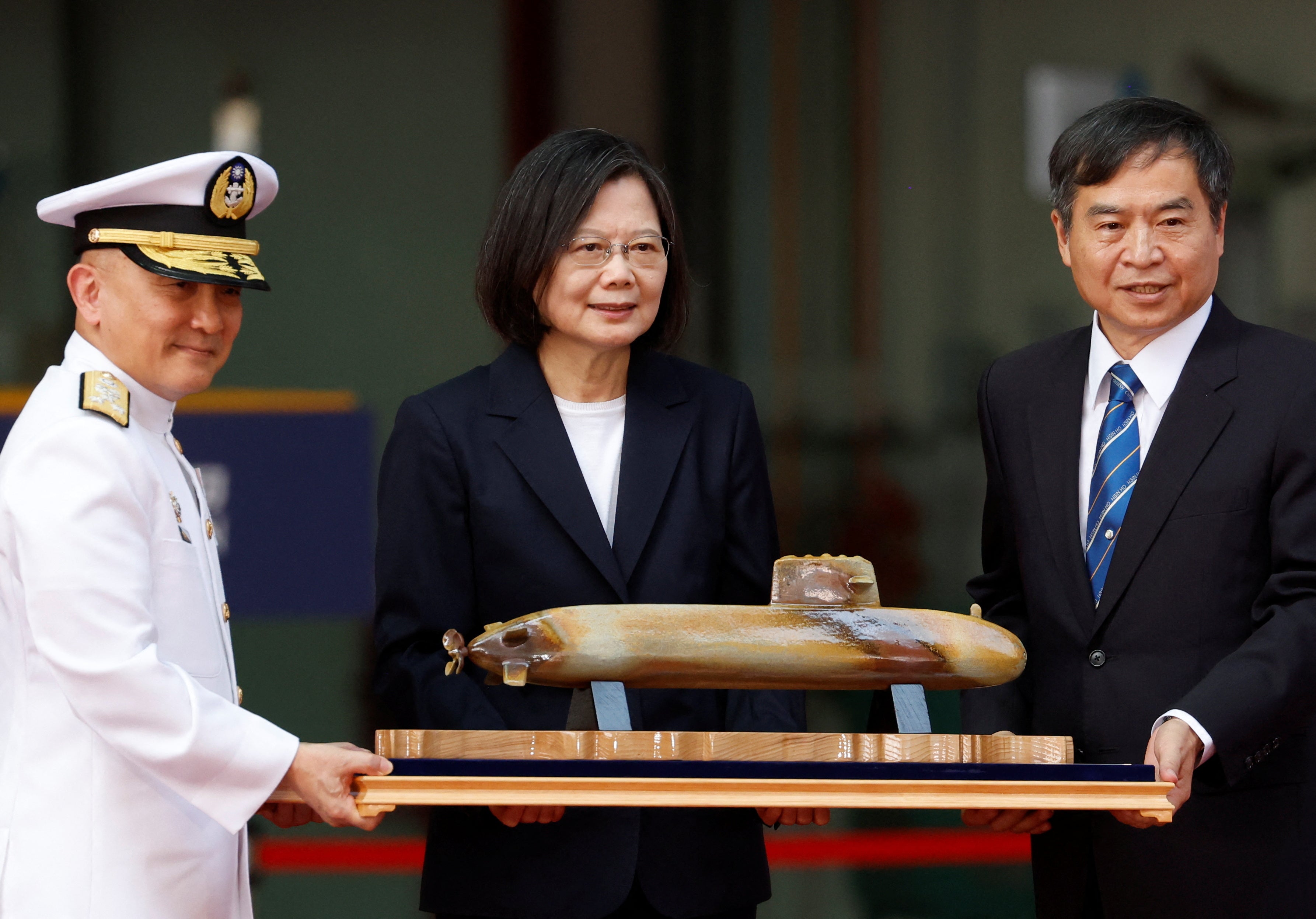 Taiwan's president Tsai Ing-wen poses for a photo with CSBC Corporation chair Cheng Wen-lon while holding a scale model of Haikun