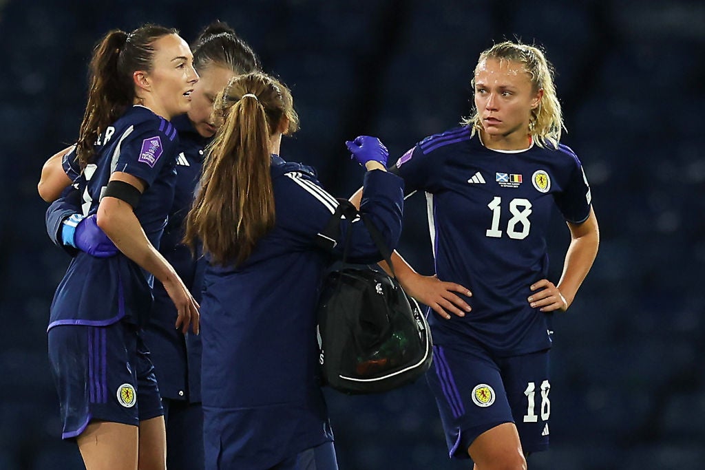 Caroline Weir is helped off the pitch at Hampden after suffering an ACL injury