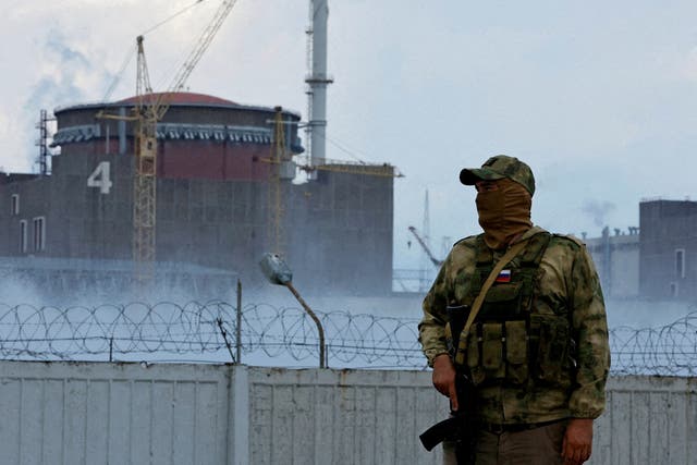 <p>A Russian soldier stands guard outside the Zaporizhzhia Nuclear Power Plant</p>