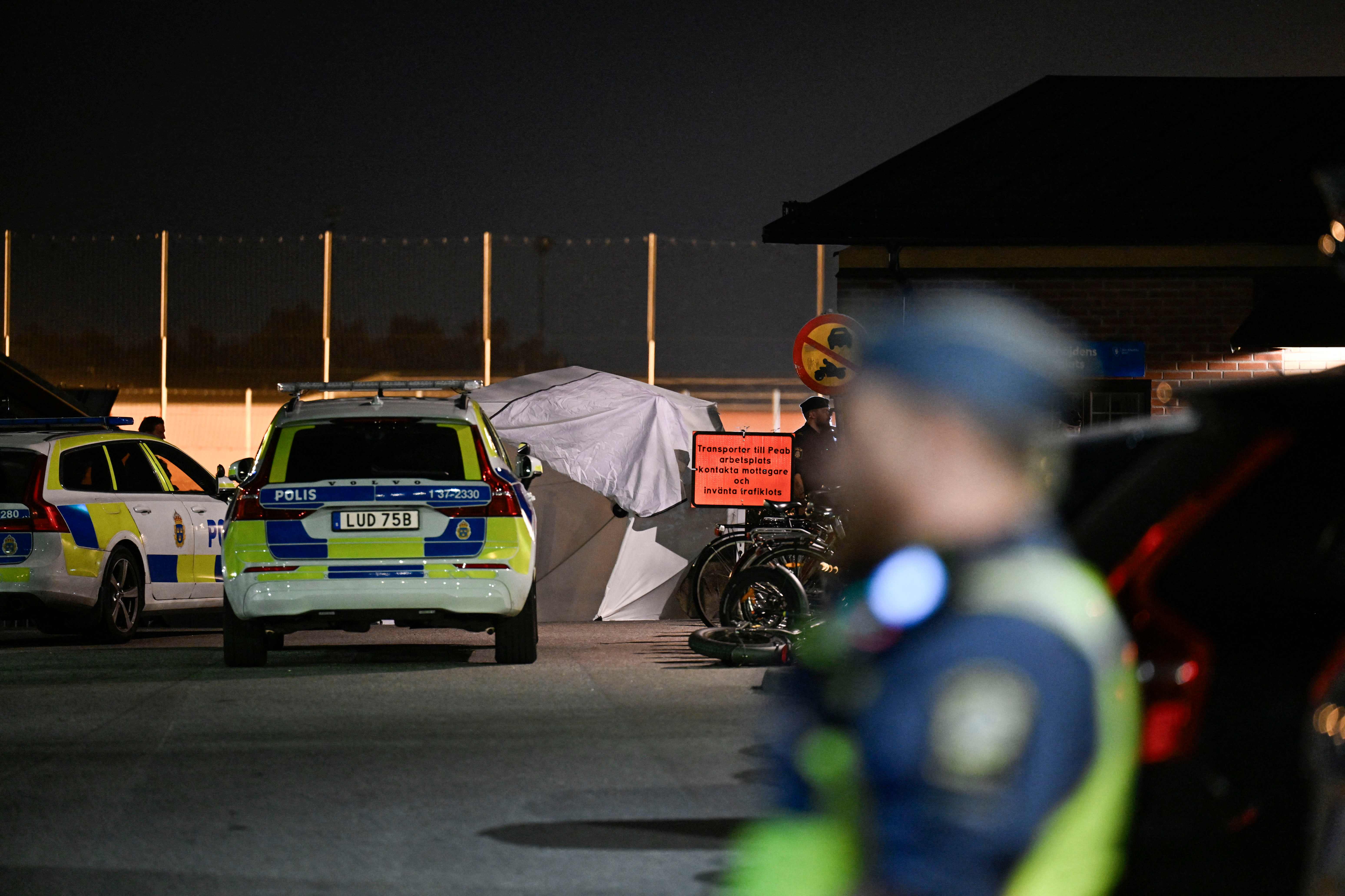 Police patrol at the scene after a shooting in Jordbro, Sweden