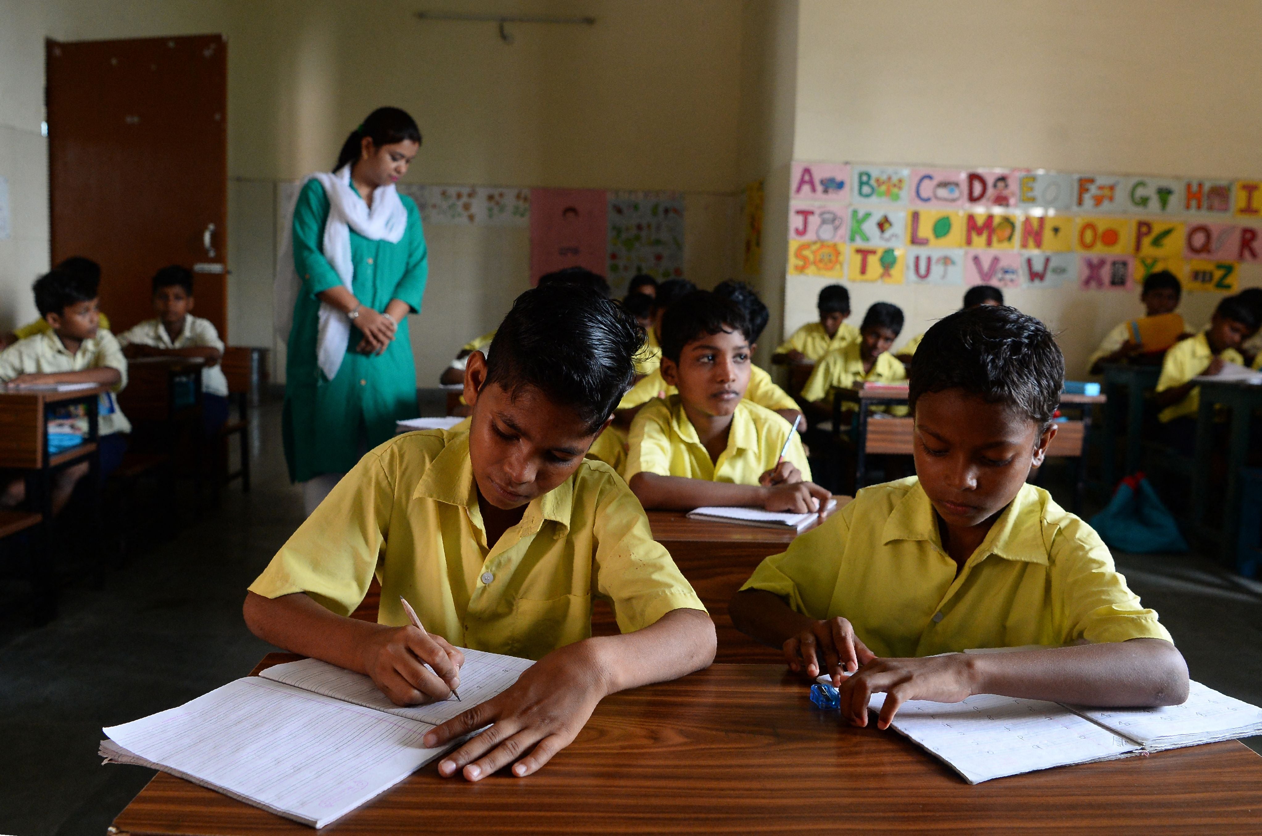 This photograph taken on 18 August 2017 shows young members of the Musahar community studying in a classroom at a school in Gonpura in Bihar