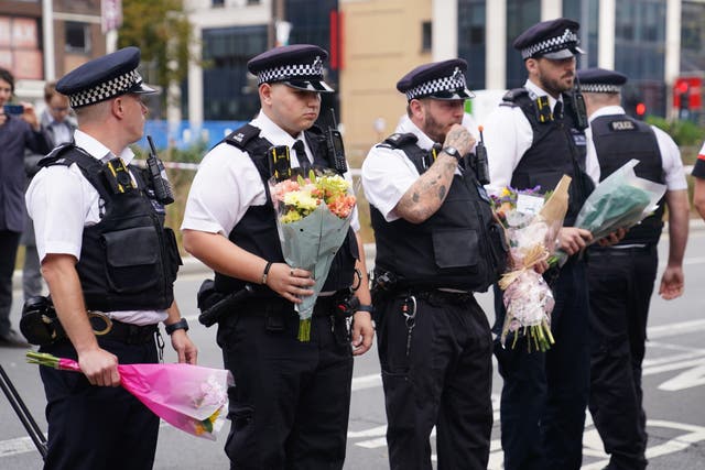 <p>Los agentes de policía depositan flores en el lugar de los hechos en Croydon.</p>