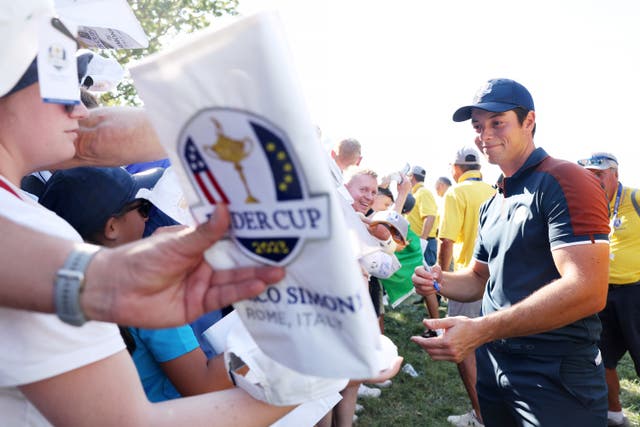 <p>Viktor Hovland signs memorabilia for fans during Thursday’s final practice round</p>