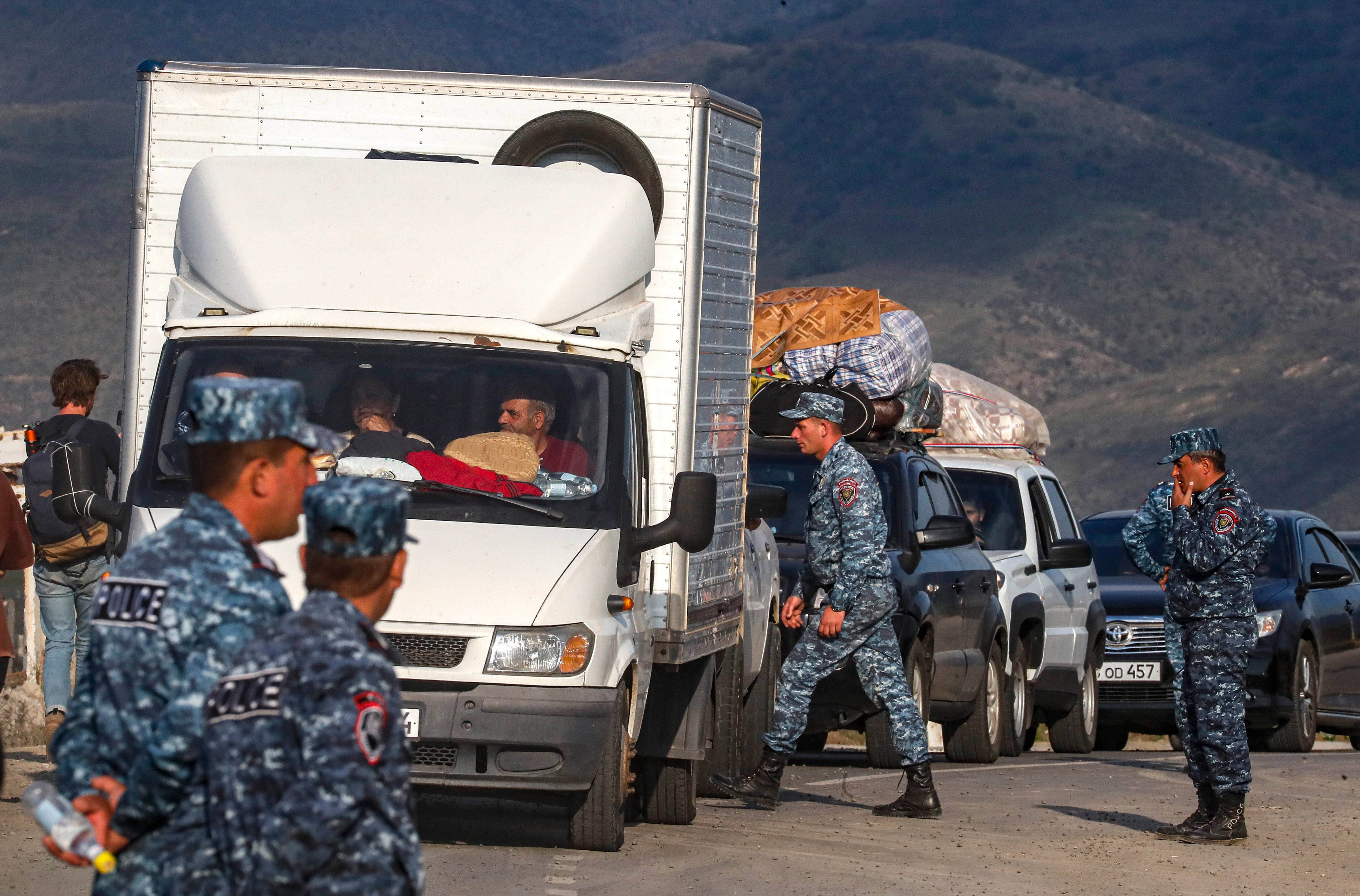 Armenian police organise passing of ethnic Armenians fleeing Nagorno-Karabakh region after they crossed the Azerbaijan-Armenia border near the village of Kornidzo