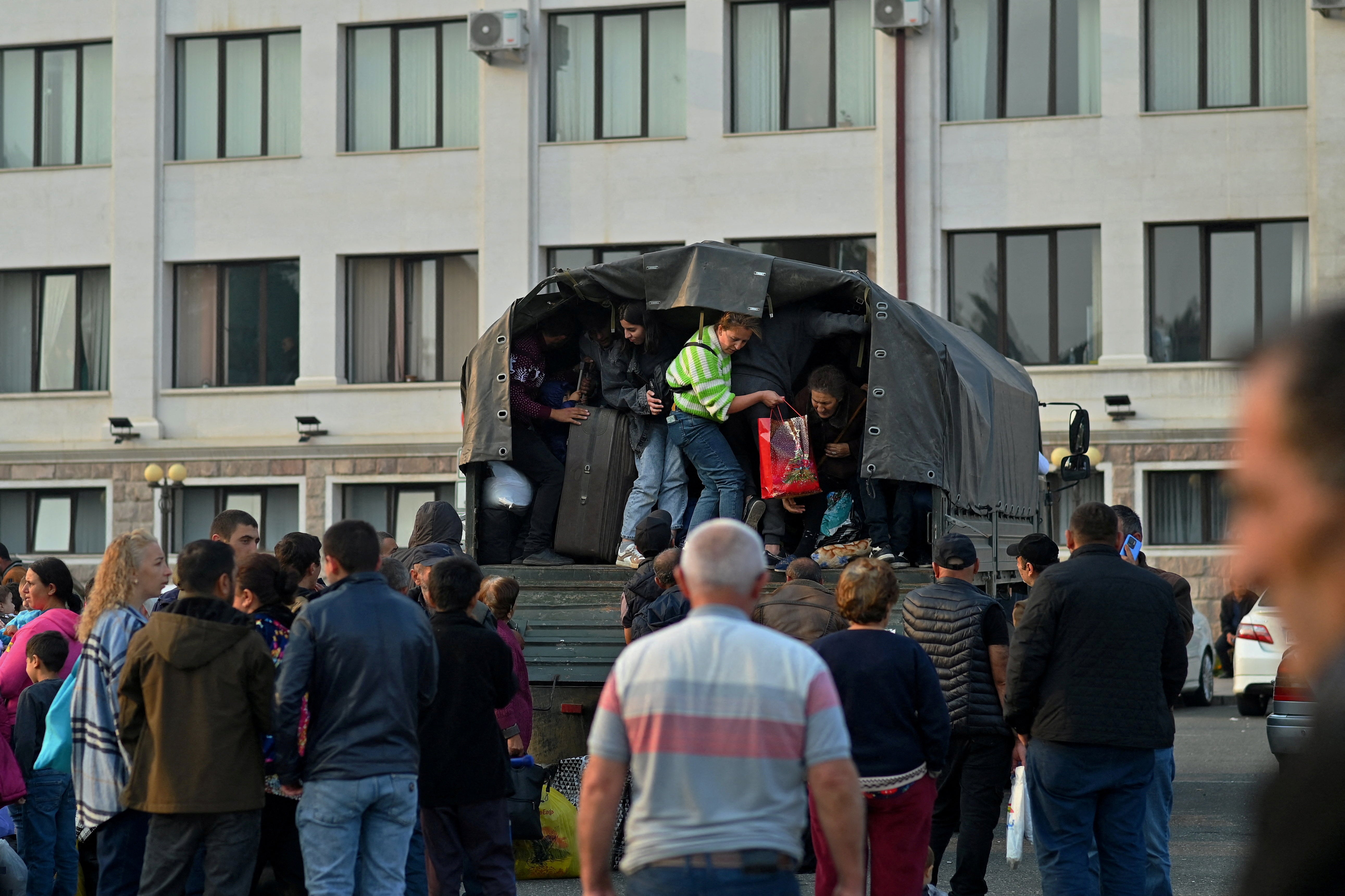 Residents board a vehicle in central Stepanakert before leaving Nagorno-Karabakh