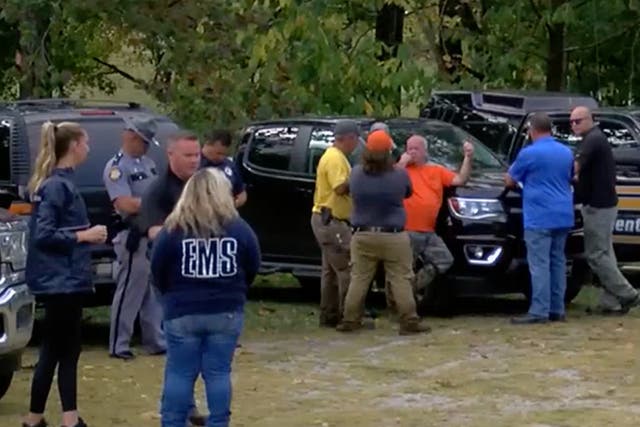 <p>Search teams are seen at a staging site near where a plane crashed in Kentucky on 28 September</p>