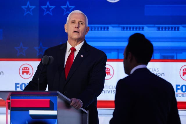 <p>Former US vice president Mike Pence looks past former biotech executive and fellow Republican presidential candidate Vivek Ramaswamy during a break in the second Republican candidates’ debate</p>