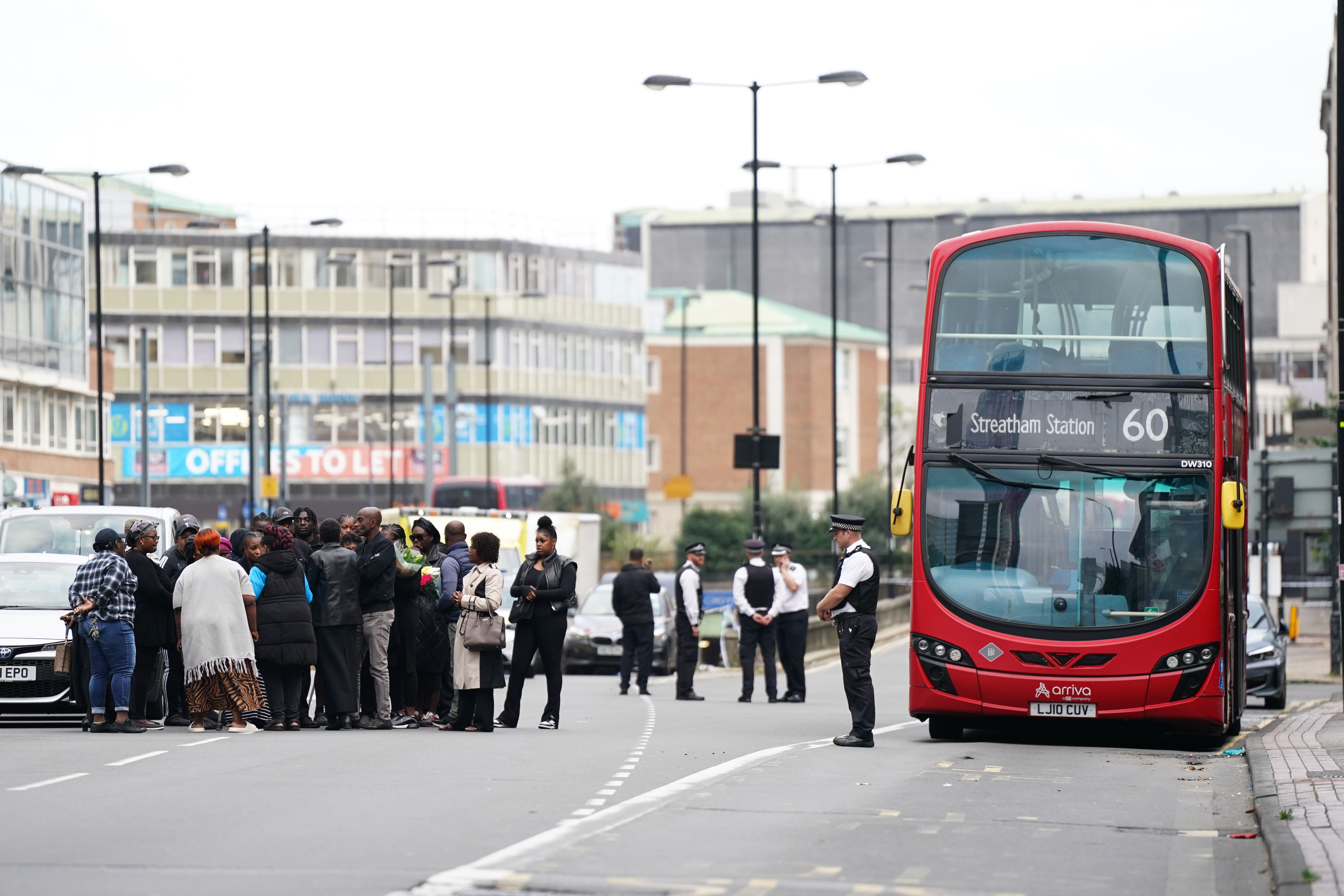 Family and friends of Elianne Andam at the scene in Croydon, south London, where 15-year-old Elianne was stabbed to death on Wednesday morning (James Manning/PA)