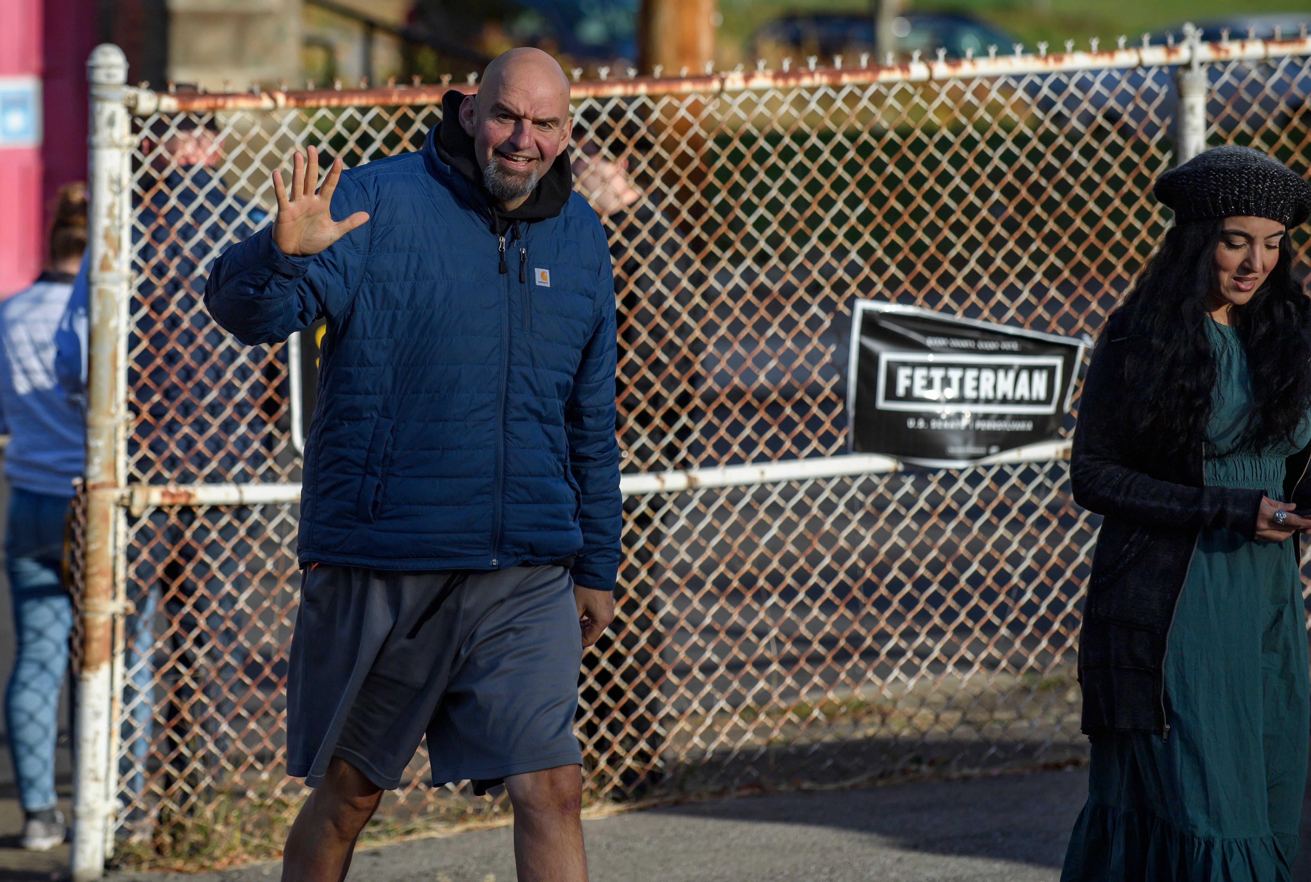 BRADDOCK, PA - NOVEMBER 08: Pennsylvania Democratic Senate candidate John Fetterman and his wife, Gisele, walk into their polling place to cast their votes at the New Hope Baptist Church on November 8, 2022 in Braddock, Pennsylvania.