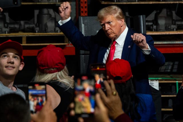 <p> Former US President and 2024 presidential hopeful Donald Trump gestures while speaking at Drake Enterprises, an automotive parts manufacturer and supplier, in Clinton, Michigan, on September 27, 2023.</p>