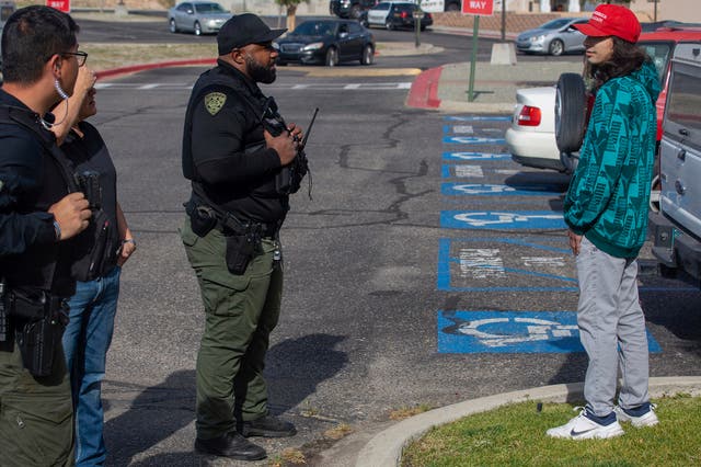 <p>Ryan Martinez, right, talks with law enforcement before violence erupted as activists protested a postponed installation of a statue of Spanish conquistador Juan de Onate</p>