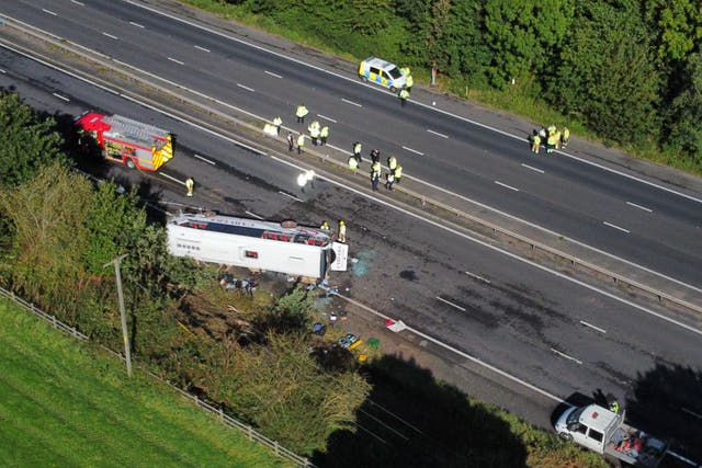 Emergency services at the scene of a coach crash on the M53 motorway (Peter Byrne/PA)