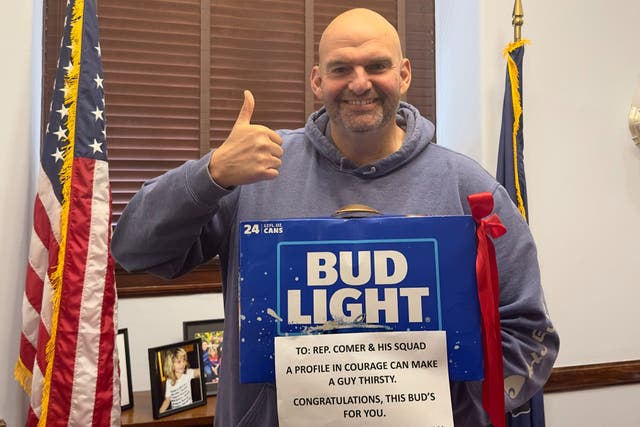 <p>John Fetterman poses with the case of Bud Light he gifted to James Comer amid impeachment hearings for President Joe Biden</p>