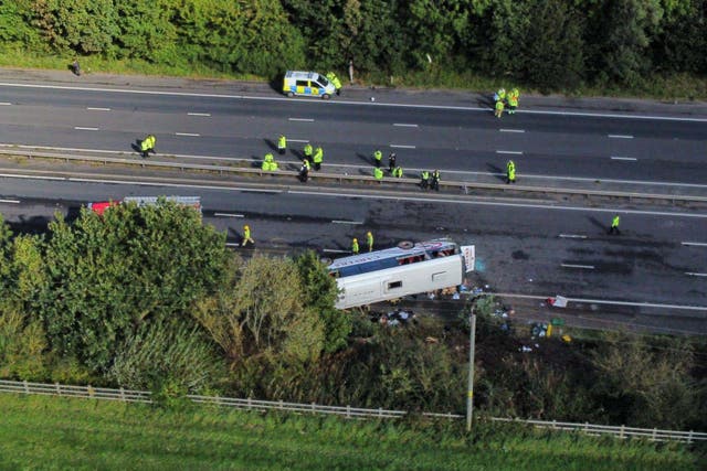 Emergency services at the scene of a coach crash on the M53 motorway (Peter Byrne/PA)