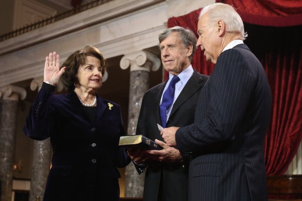 Dianne Feinsteinparticipates in a reenacted swearing-in with her husband Richard C. Blum and Vice President Joe Biden in the Old Senate Chamber on 3 January 2013