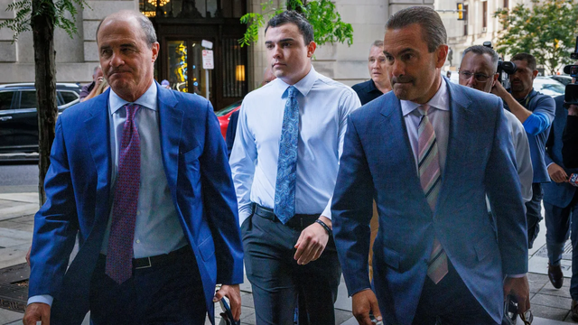 <p>Former police officer Mark Dial (centre) making his way to court for his bail hearing</p>
