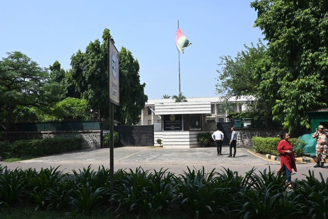 <p>People stand outside the Afghan Embassy in New Delhi</p>
