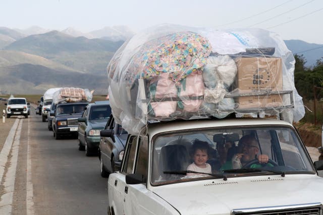 <p>Ethnic Armenians cross the border with Azerbaijan on Friday </p>