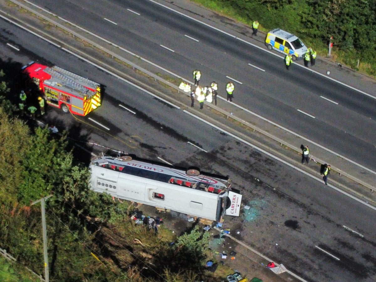 Girl of 14 and driver killed as school coach overturns and crashes on motorway