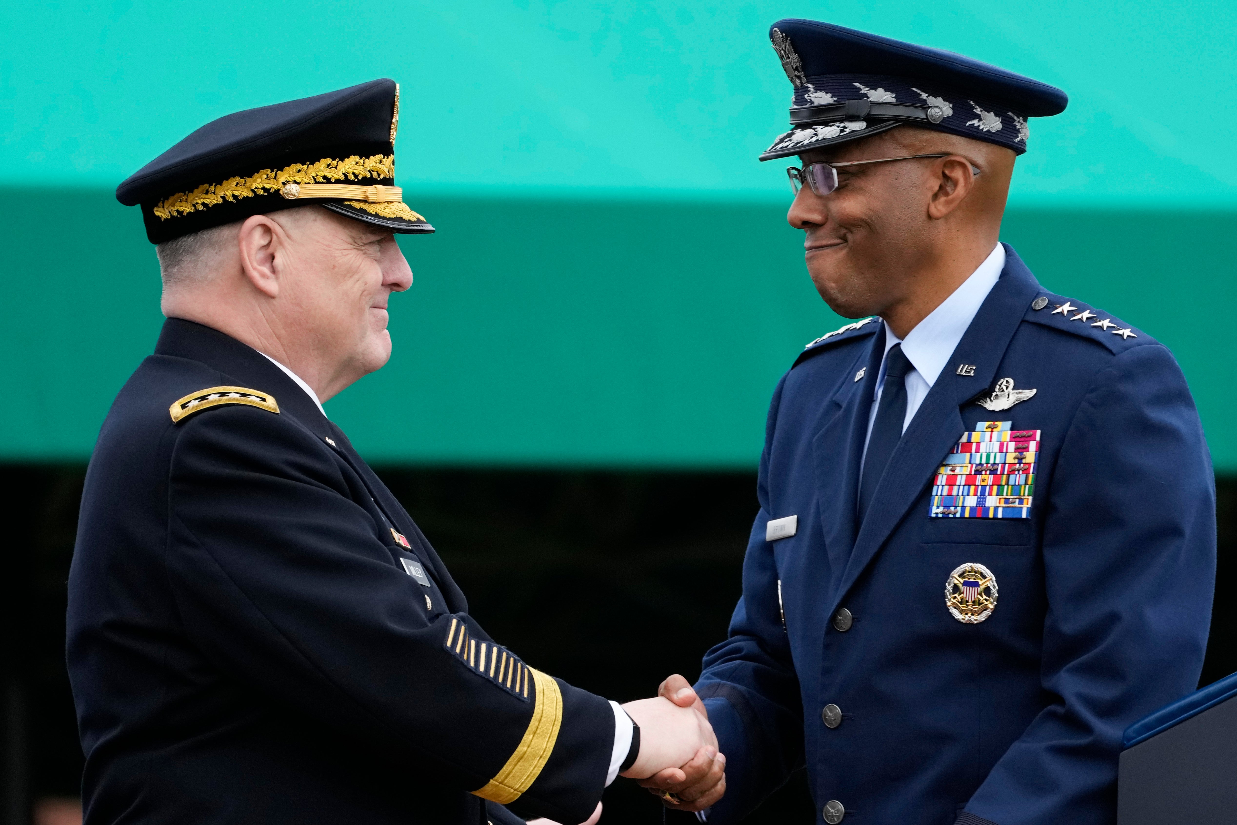 Retiring Chairman of the Joint Chiefs of Staff Gen. Mark Milley, left, shakes hands with Gen. Charles Q Brown Jr, the incoming chairman