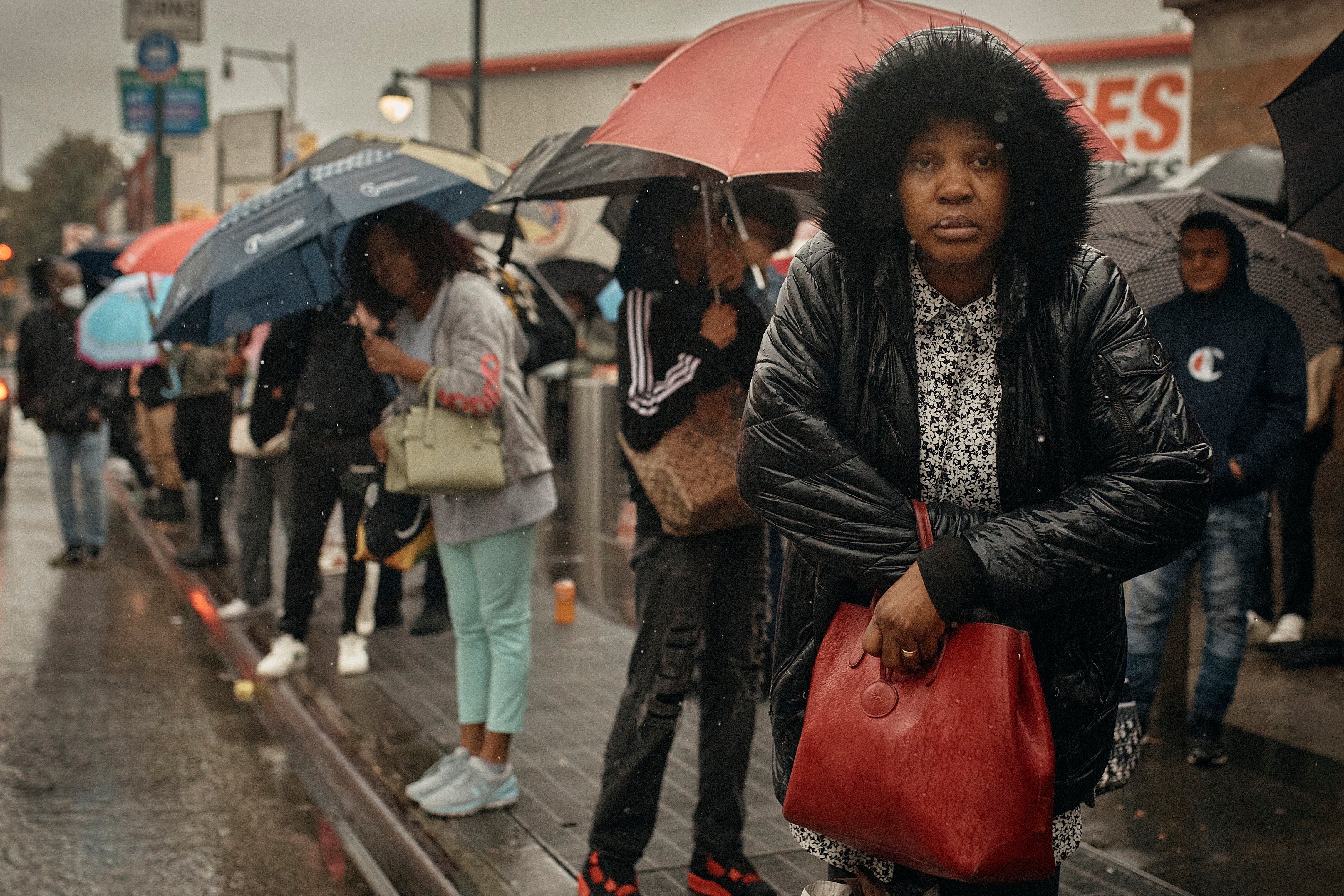 People wait for the bus as trains were cancelled last Friday across large parts of New York following a severe storm