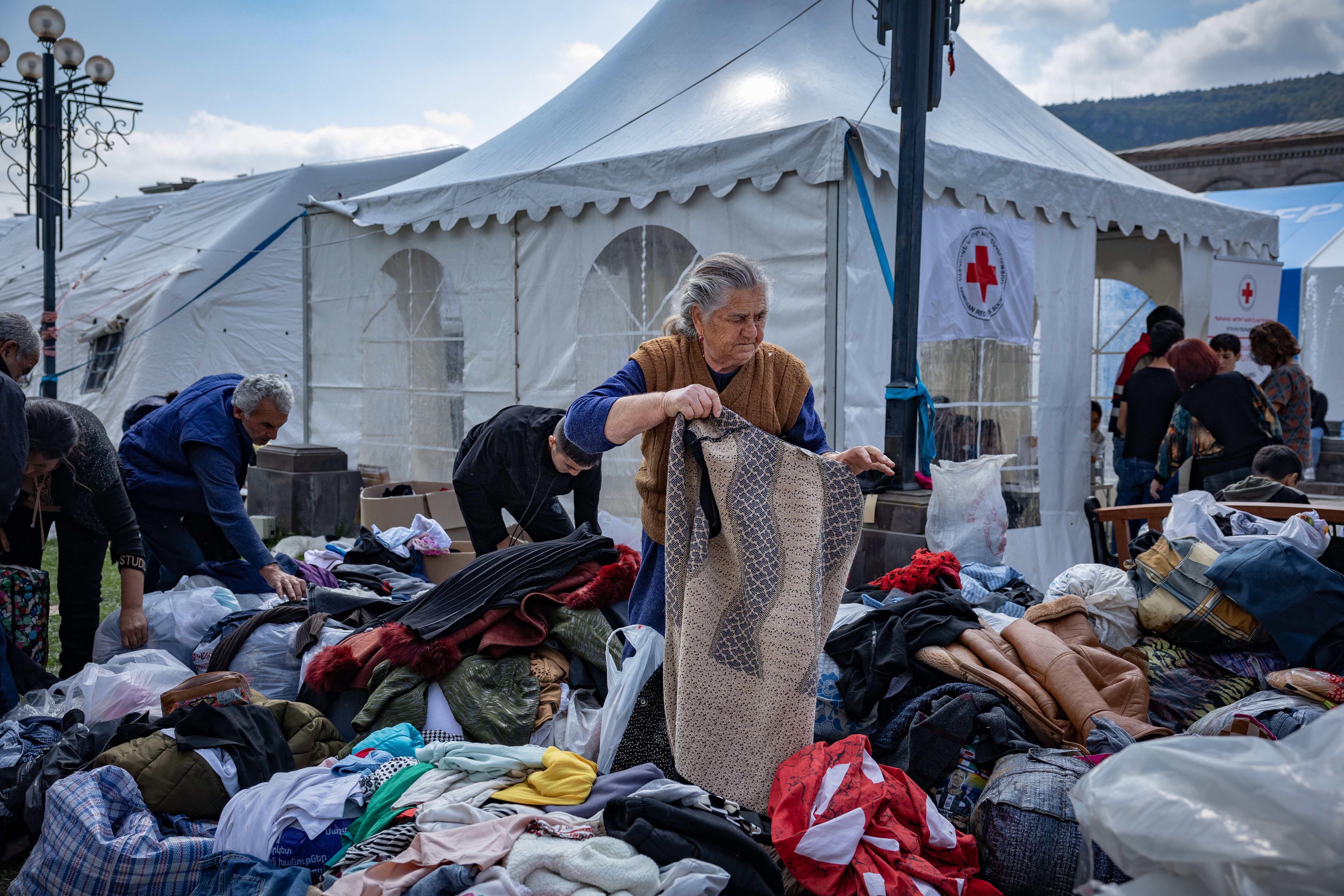 Refugees pick through donated clothes as they were forced to leave everything behind when fleeing Nagorno Karabakh