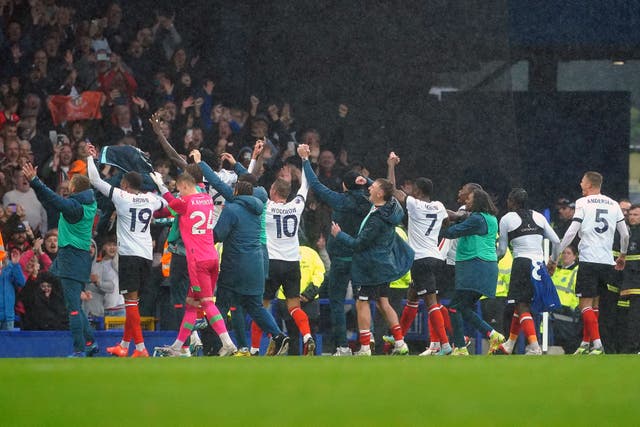 Luton players celebrate their first Premier League win with their fans (Peter Byrne/PA)
