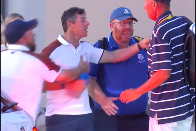<p>Rory McIlroy gestures furiously in discussion with US caddie Jim ‘Bones’ Mackay</p>