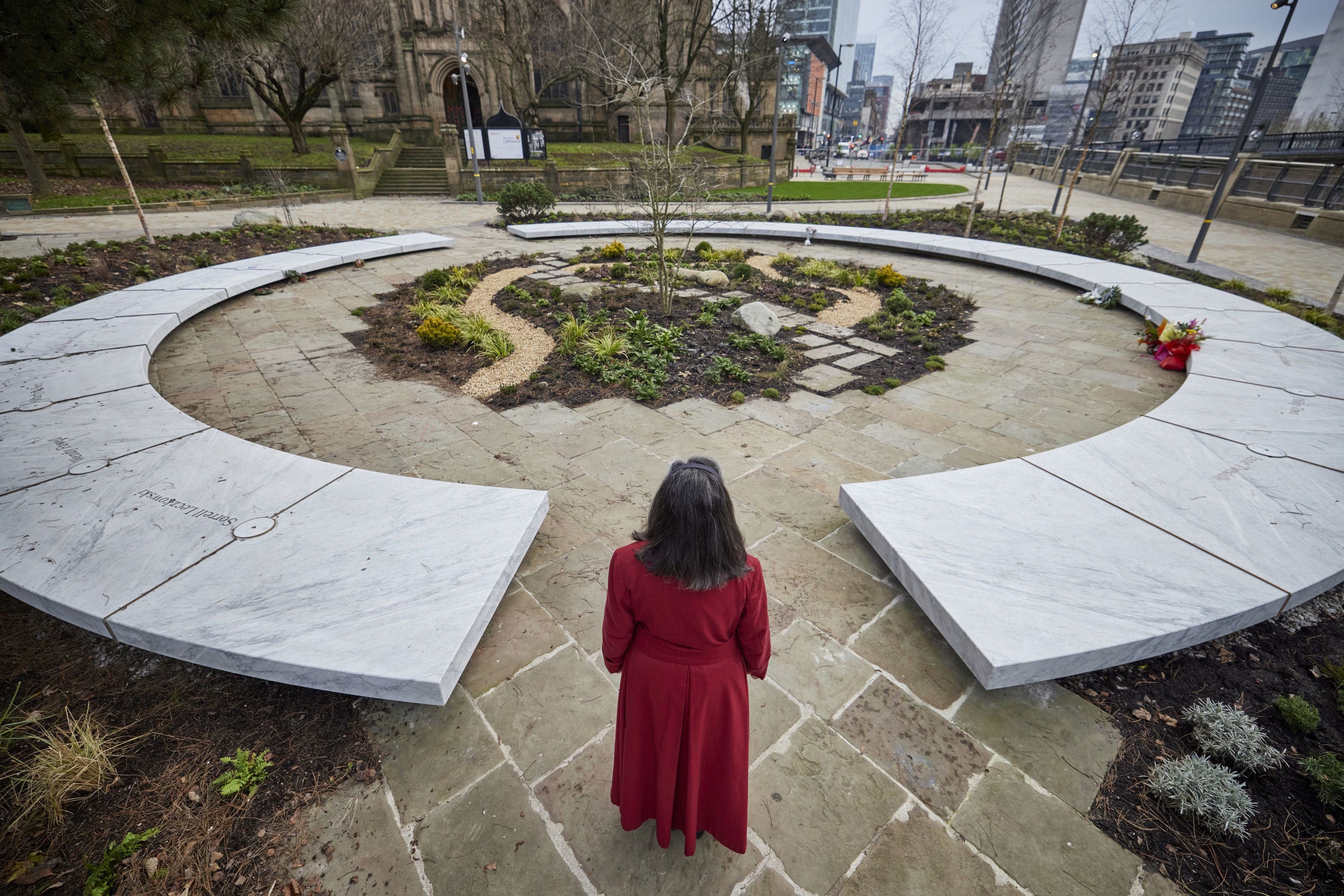 A woman by the Glade of Light, a memorial to the 22 people murdered in the Manchester Arena terror attack (Mark Waugh/Manchester City Council/PA)
