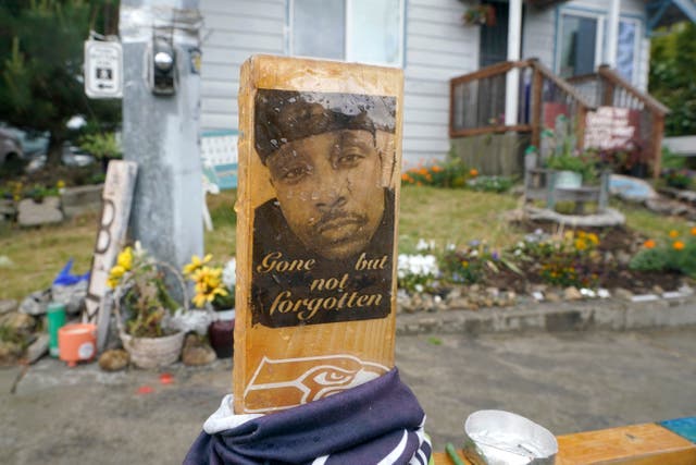 <p>A sign is displayed in 2021, at a memorial in Tacoma, Washington where Manuel ‘Manny’ Ellis died on 3 March 2020</p>