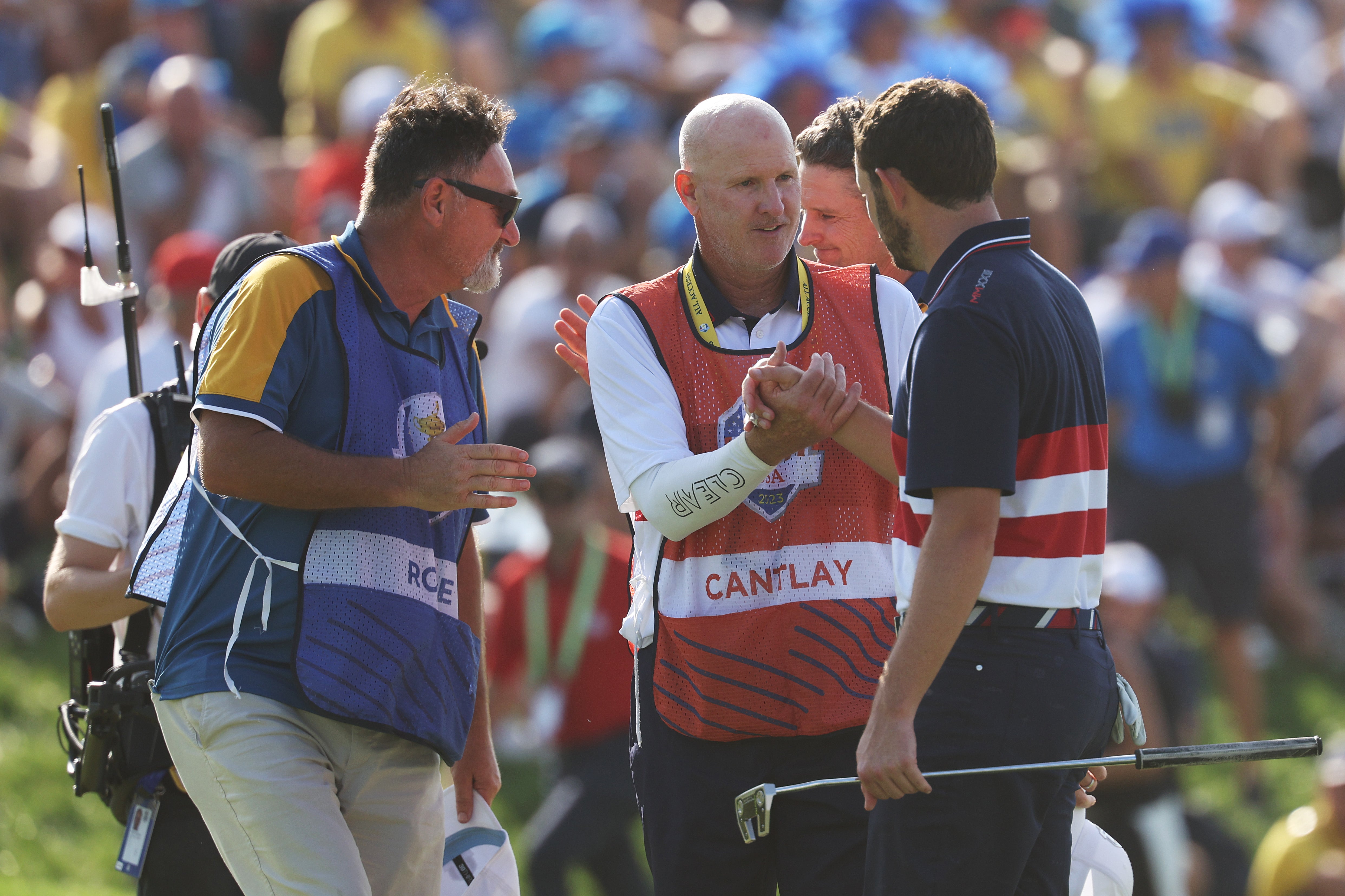 Patrick Cantlay shakes hands with caddie Joe Lacava