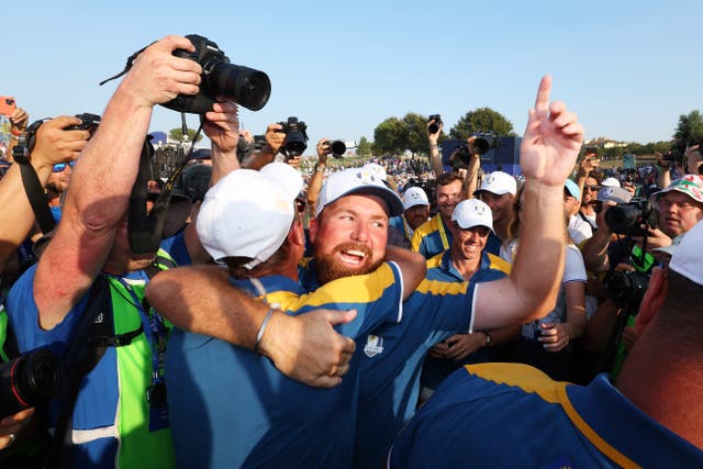 <p>Sepp Straka embraces teammate Shane Lowry in celebration on the 18th green</p>