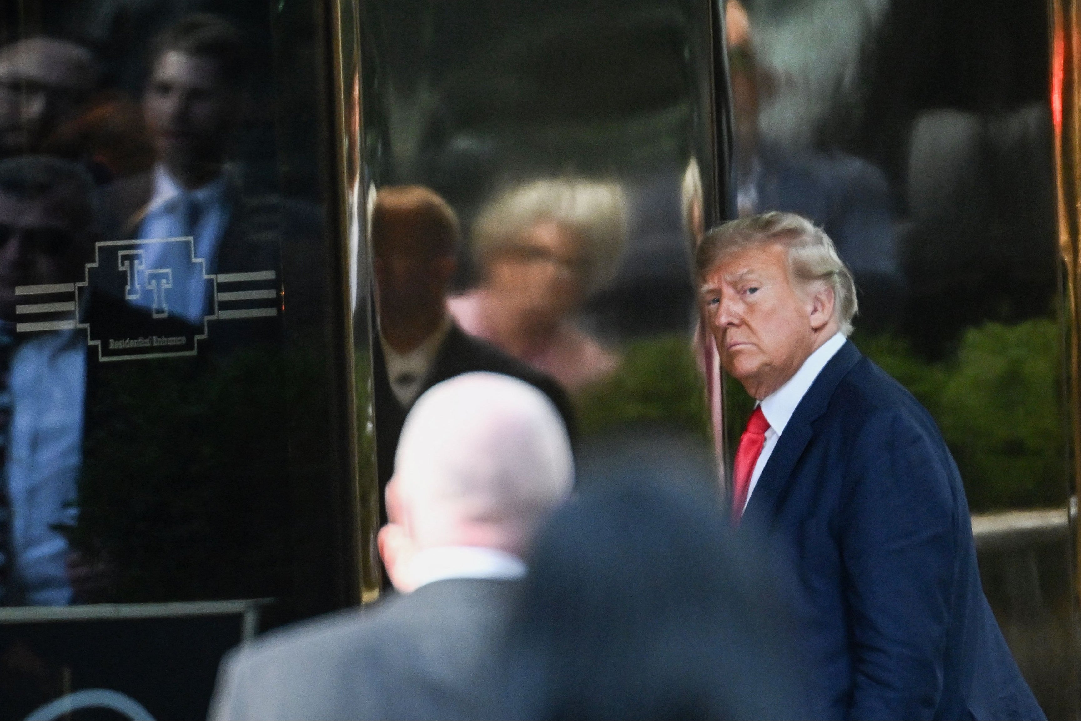 <p>Former US president Donald Trump walking into Trump Tower in New York in April. The fraud lawsuit against him risks bringing down his business empire </p>