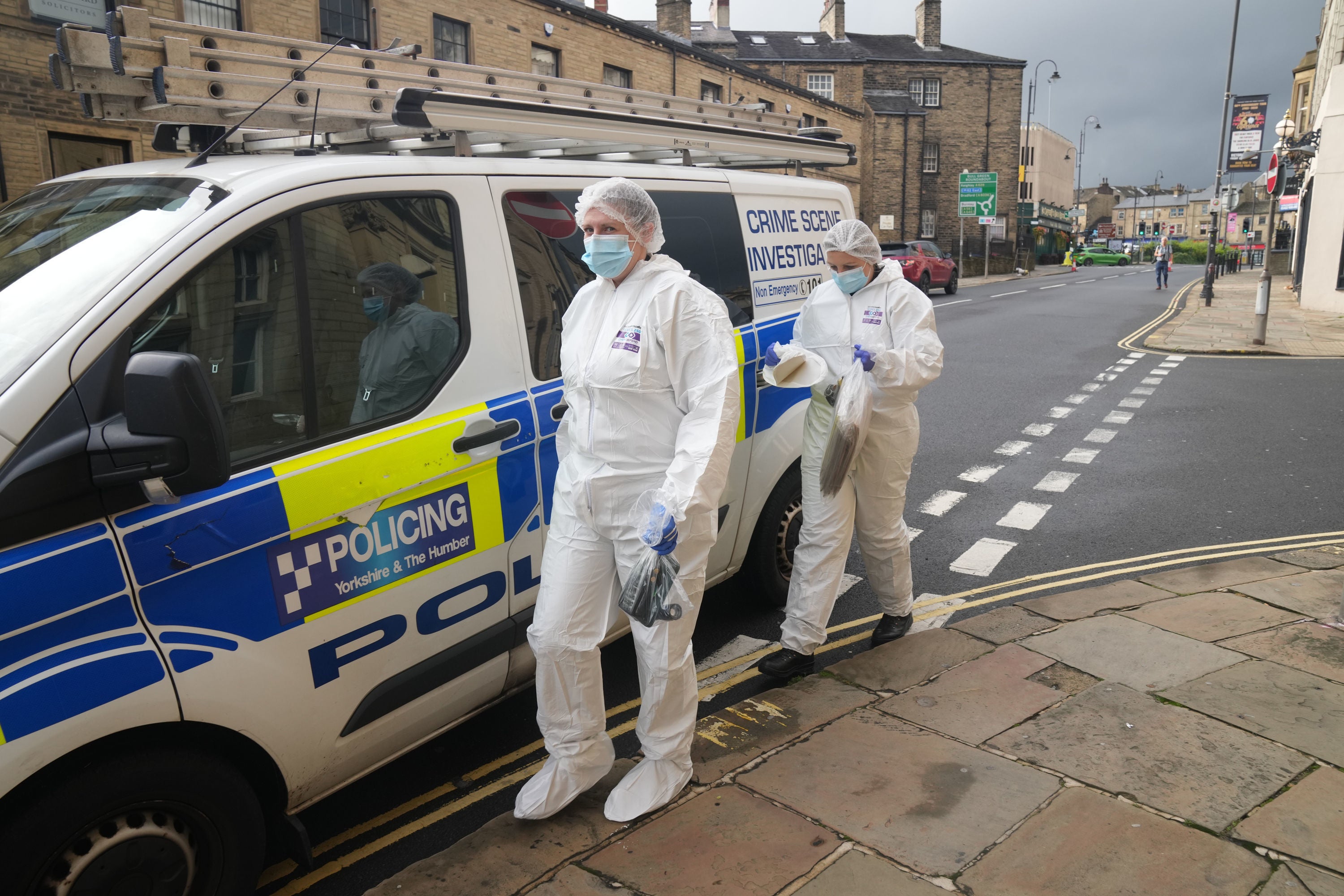Crime scene investigators in Halifax on Sunday where another man was also stabbed to death