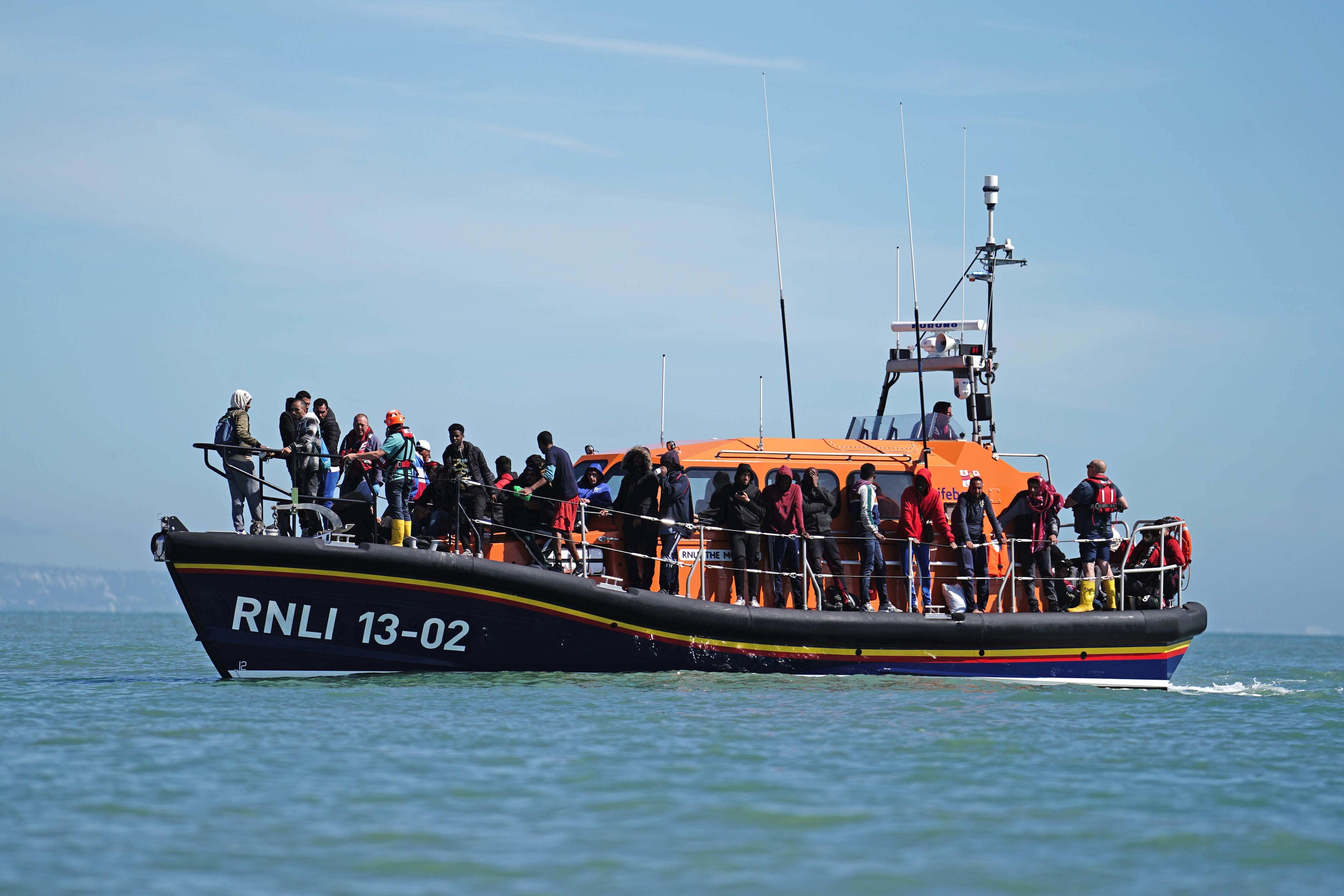 A group of people thought to be migrants are brought in to Dungeness, Kent, on a lifeboat (PA)