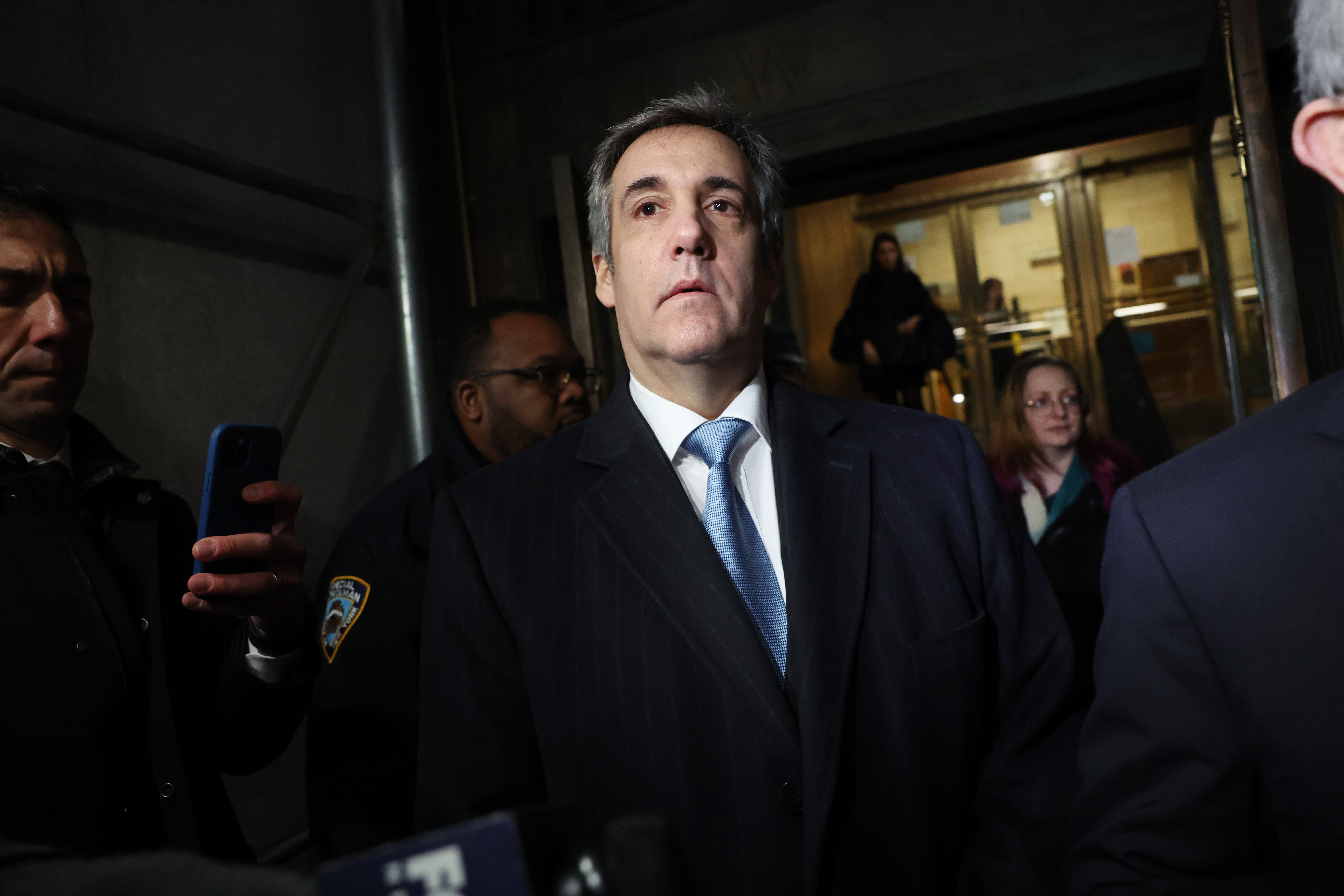 Michael Cohen walks out of a Manhattan courthouse after testifying before a grand jury in the hush money case