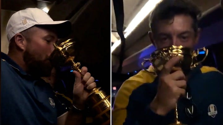 <p>Rory McIlroy and Shane Lowry drink from Ryder Cup trophy as Team Europe teammates chant ‘USA is terrified’.</p>