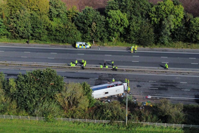 Emergency services at the scene of the coach crash on the M53 on Friday (Peter Byrne/PA)