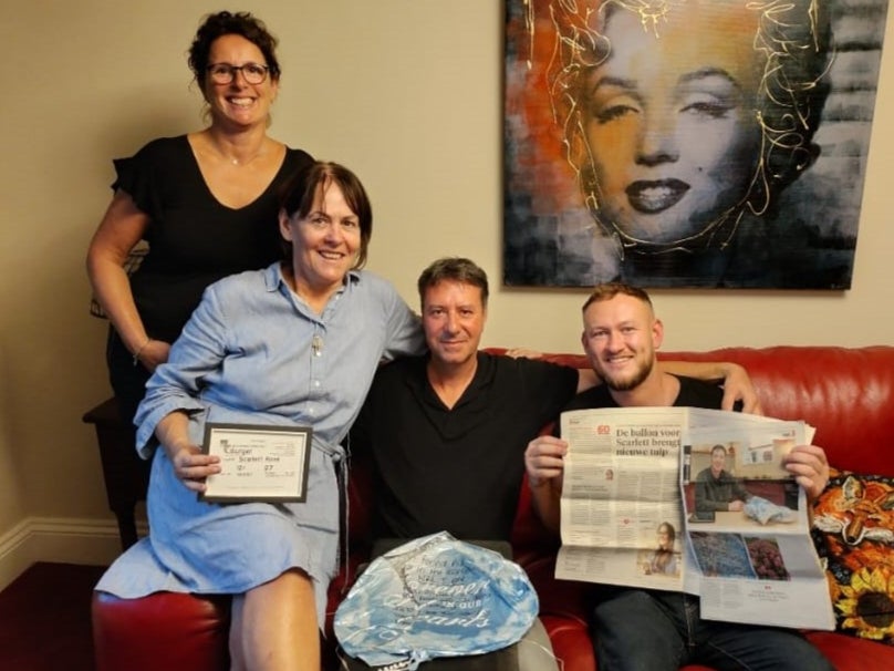 <p>Marisska Burger (left), Kate O’Malley (in blue dress), Pieter Burger and Levi O’Malley (right) with the balloon and a Dutch newspaper article about the story.</p>