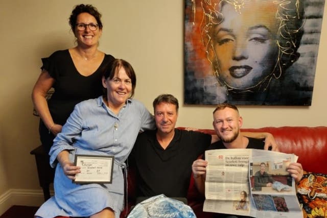 <p>Marisska Burger (left), Kate O’Malley (in blue dress), Pieter Burger and Levi O’Malley (right) with the balloon and a Dutch newspaper article about the story.</p>