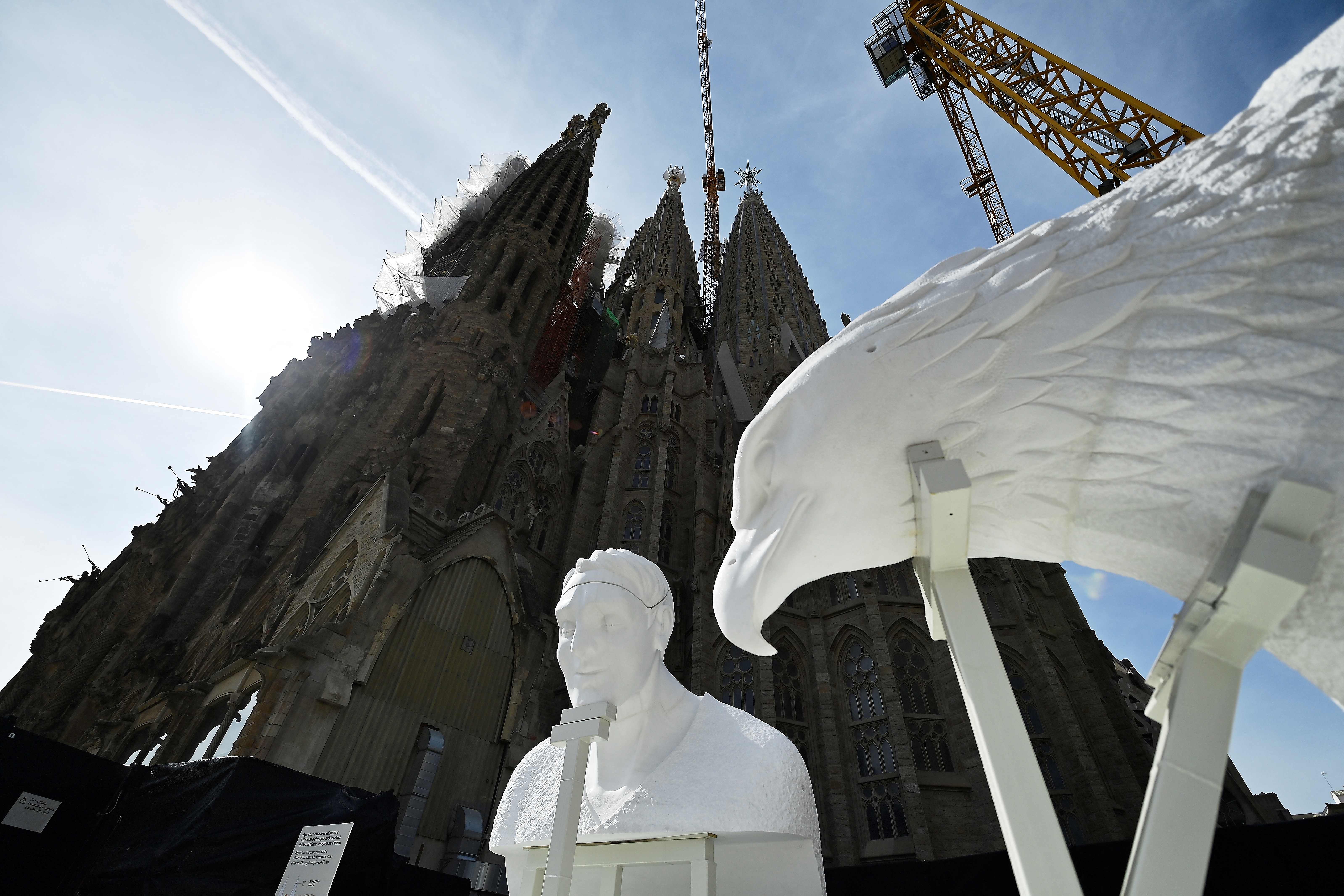 This picture taken on September 19, 2023 shows a pinnacle depicting a human figure that will be set on Evangelist Matthew's tower and an eagle figure that will be set on the Evangelist John's tower, both at 135 meters high, during a press conference to announce the new steps in the construction of the Expiatory Church of the Sagrada Familia basilica in Barcelona