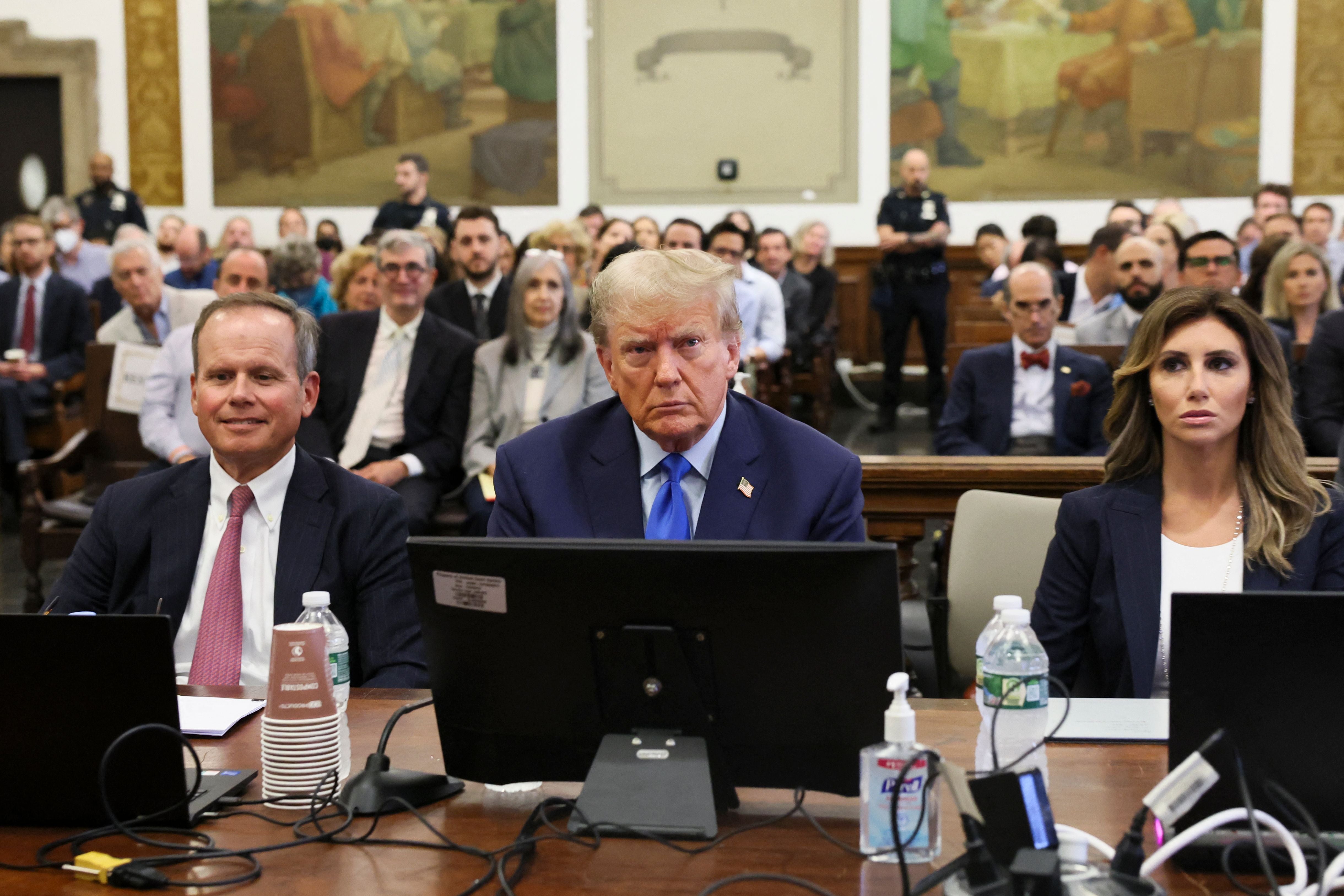 Donald Trump, centre, appears in court on 2 October with his attorneys Christopher Kise, left, and Alina Haba, right.