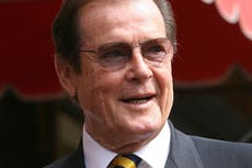 Roger Moore’s lookalike sons steal show at auction of Bond star’s belongings
