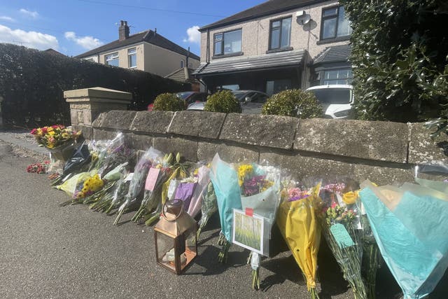 Floral tributes left outside a house on Hemper Lane, Greenhill, Sheffield, following the death of Marcia Grant (Dave Higgens/PA)