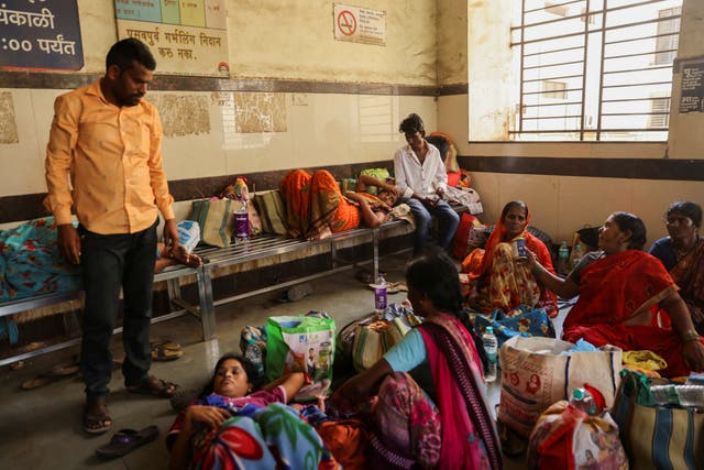 <p>Relatives of patients admitted at the Shankarrao Chavan Government Medical College and Hospital are seen inside the hospital, in Nanded</p>