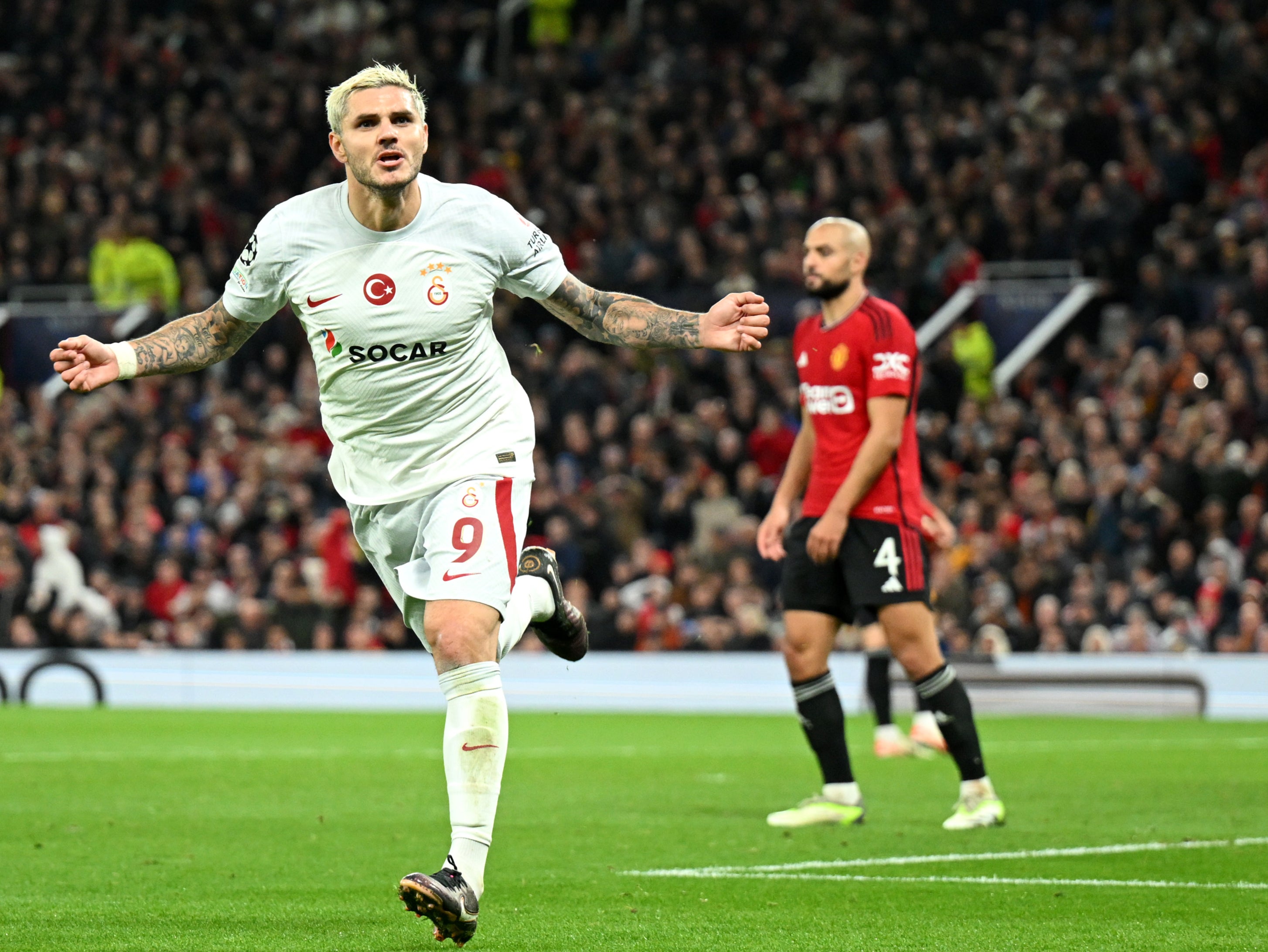 Galatasaray's Mauro Icardi, top, heads the ball with Manchester