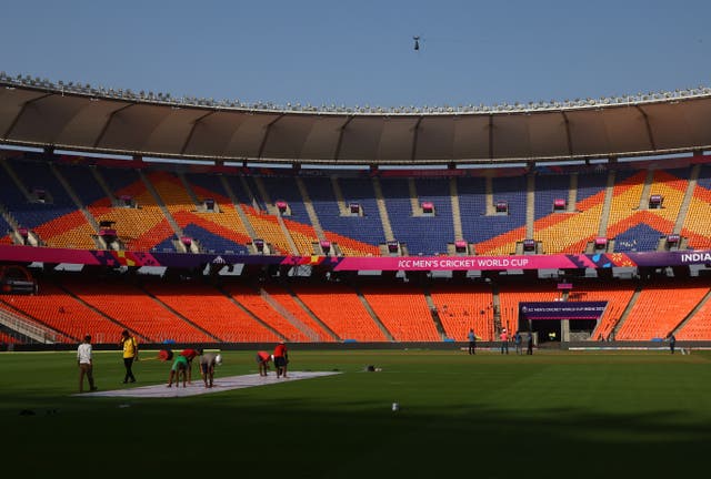 <p>General view of ground staff preparing the Narendra Modi Stadium in Ahmedabad on 4 October</p>