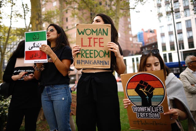 <p>Women hold placards during a global protest in solidarity with Iranian women in New York on the first anniversary of the death of Iranian Kurd Mahsa Amini in custody</p>