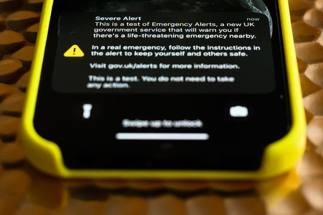 <p>A mobile phone displays a nationwide public alert system test message on 23 April, 2023 in London, United Kingdom</p>