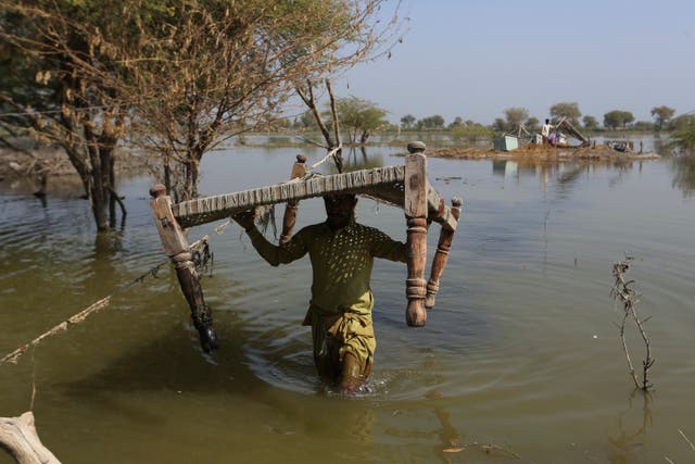<p>File image: A man retrieves belongings, which were they kept on the higher ground surrounded floodwaters, at a village in Sohbat Pur, Baluchistan following heavy rainfall in October last year. Forecasters are warning of above average rainfall this year  </p>
